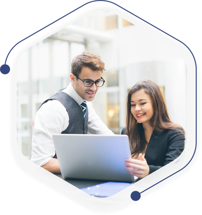 A man and woman looking at a laptop.